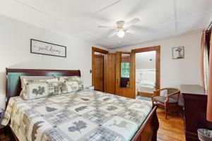 a bedroom with a bed and a ceiling fan at The Hollow in Jefferson