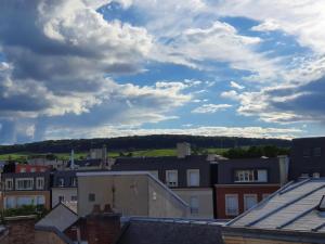 a view of a city with buildings and clouds at The Clubhouse -Hypercentre Epernay in Épernay +4 photos