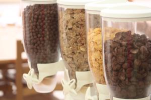 a group of four containers filled with nuts and cereal at Rivotorto Retreat House in Birkirkara
