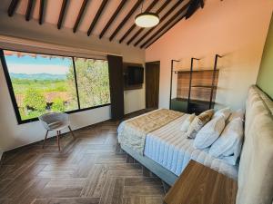 a bedroom with a bed and a large window at Antara Resort in Alcalá +87 photos