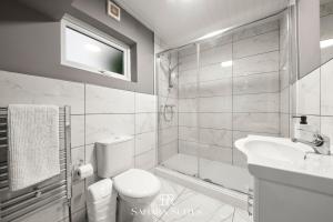 a bathroom with a toilet and a sink and a tub at Guest Fav - Luxury 5BR - Reading Centre - Monthly Stays - Parking in Earley +19 photos