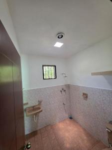 a bathroom with a urinal and a window on the wall at La Casita de Uribe in Valladolid