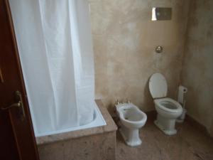 a bathroom with a toilet and a shower and a tub at LA GASTALDIA in Pontecasale