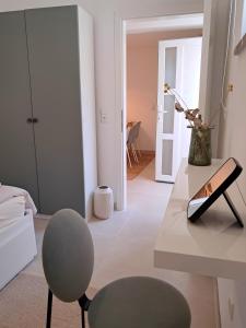 a living room with a table and a chair at Olive Apartment Rovinj in Rovinj