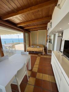 a room with a kitchen and a bedroom with a bed at La Suite del Mare in Taranto