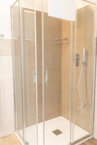 a shower with glass doors in a bathroom at Celestino V in Sulmona +39 photos