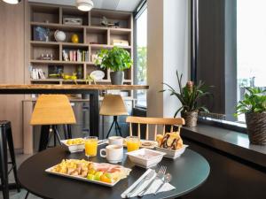 a breakfast table with food on it in a room at ibis Genève Centre Gare in Geneva