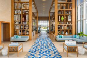 a lobby with couches and tables and a rug at Dreams Cap Cana Resort & Spa - All Inclusive in Punta Cana +101 photos