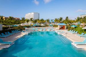 a swimming pool with lounge chairs and a resort at Dreams Cap Cana Resort & Spa - All Inclusive in Punta Cana