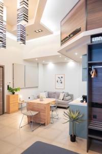 a living room with a table and chairs at Evis Cosmos 1 - Meno Homes 10 in Xanthi