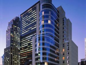 a tall building with many windows in a city at Sofitel New York in New York