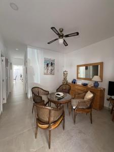 a living room with a table and chairs at Isla Sicilia in Oliva