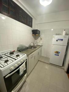 a kitchen with a stove and a refrigerator at Departamento Gallino PB in Corrientes