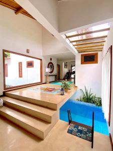 a living room with a swimming pool and stairs at Paraíso Casa Branca in Arraial d'Ajuda