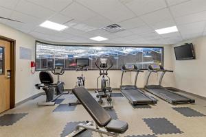 a gym with treadmills and ellipticals in a room at Executive Residency by Best Western Waterloo & Cedar Falls in Waterloo
