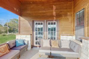a porch with two couches and a window at Headquarters Hideaway in Fredericksburg