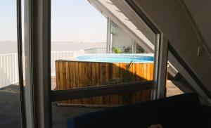 a view of a swimming pool through a window at LUX IN THE AIR - An Elevated Experience on the Vaal Dam in Denysville +7 photos