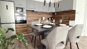 a kitchen with a dining room table and chairs at Z Apartman in Nyíregyháza