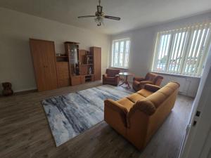 a living room with a couch and two chairs at WlodawaSpot in Włodawa