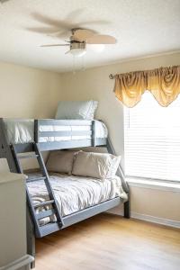 a bedroom with two bunk beds and a window at The Breeze in Navarre