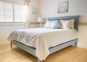 a bedroom with a large bed with a blue headboard at The Breeze in Navarre +27 photos