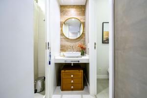 a bathroom with a sink and a mirror at Live a dream in the heart of LEBLON in Rio de Janeiro +13 photos
