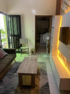 a living room with a couch and a coffee table at Doumassou Studio in Dakar