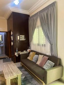 a living room with a couch and a window at Doumassou Studio in Dakar
