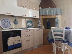 a kitchen with a sink and a stove top oven at Appartamento Onda Marina in Polignano a Mare