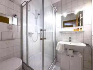 a bathroom with a shower and a sink and a toilet at Landhaus Steibis - FEWO 4 Gipfel in Steibis +35 photos