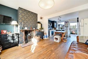 a living room with a couch and a fireplace at South Downs home in Ditchling
