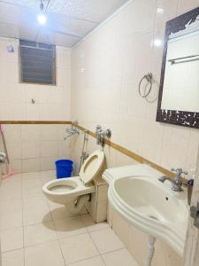 une salle de bains avec toilettes et lavabo dans l'établissement Elite Stays Viman Nagar, à Pune