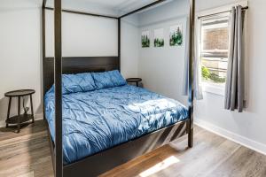 a bedroom with a bed and a window at Walk and Bike Great Miami River Trail Dayton Home in Dayton