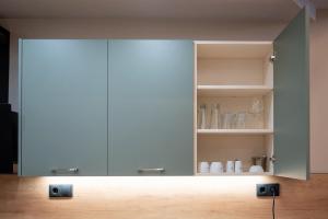 a white cabinet with doors and shelves in a room at Evis Cosmos 1 Center - Meno Homes 10 in Xanthi
