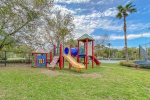 a playground with a slide in a park at Palms of Destin 1805 in Destin