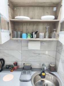 a kitchen with a sink and a counter top at Sweet home in Bor +10 photos