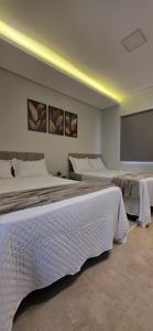 a bedroom with two beds and a projection screen at Cantinho Martins in Prado +53 photos