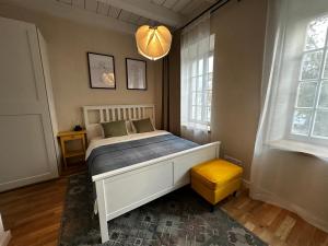 a bedroom with a bed and two windows at Independence square apartments I in Mažeikiai