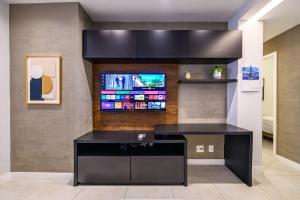 a kitchen with a black island in a room at Live a dream in the heart of LEBLON in Rio de Janeiro