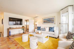 a living room with a couch and a table at Amazing location, Unique Oceanfront Beach House! in Manhattan Beach