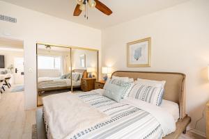 a bedroom with a large bed and a mirror at Amazing location, Unique Oceanfront Beach House! in Manhattan Beach