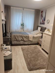 a small bedroom with a bed and a television at Deluxe Einzelzimmer nur für max 1 Nacht buchbar abends rein morgens raus in Bielefeld