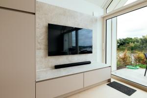a living room with a tv on a wall at Mase waterunits 6 & 7 in Maaseik