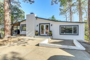 a white house with trees in front of it at Prescott Retreat with Hot Tub about 3 Mi to Dtwn! in Prescott