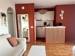 a kitchen and a living room with a radiator in a room at El Minorq'In in Cala en Porter