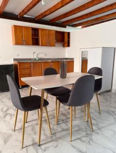 a kitchen with a white table and chairs at Casa Madeira in Rionegro +13 photos