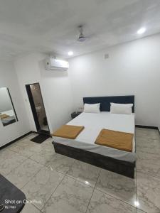 a bedroom with a large bed in a room at Dwarka Sai Palace in Dwarka