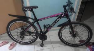 a bike sitting on a kickstand in a room at Seaview Hilltop chalet, with AC, private bathroom, kitchen & balcony with views in Coron