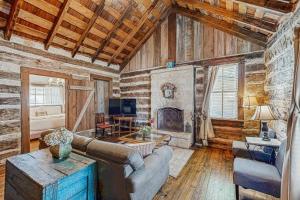 a living room with a couch and a fireplace at Historic Rocky Hill- Full Property in Fredericksburg