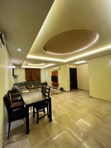 a living room with a table and a couch at اجنحة النرجس للشقق المخدومة in Abha